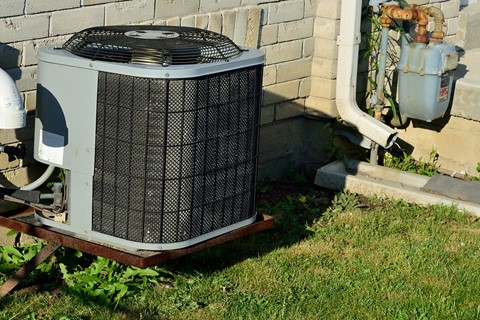 Three hvac units outside of homes