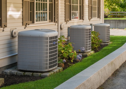 Three hvac units outside of homes