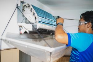man working on cleaning indoor ac unit and air ducts