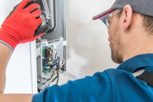 male technician performing a furnace tune up